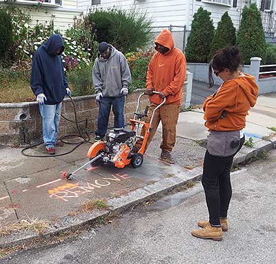 Cutting away a section of the sidewalk.