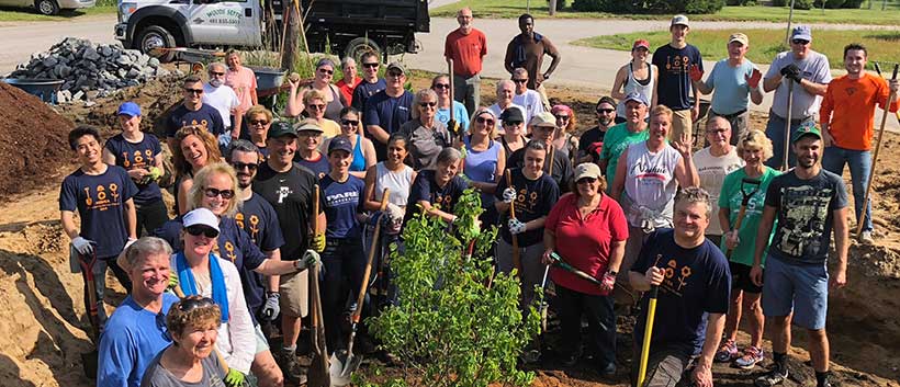 A big group of people putting in plantings at Common Fence Point